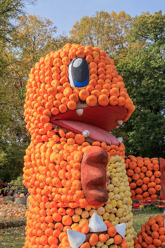 A large pumpkin sculpture shaped like Charmander.
