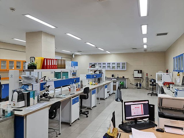 A bright laboratory filled with equipment, desks, and computers.